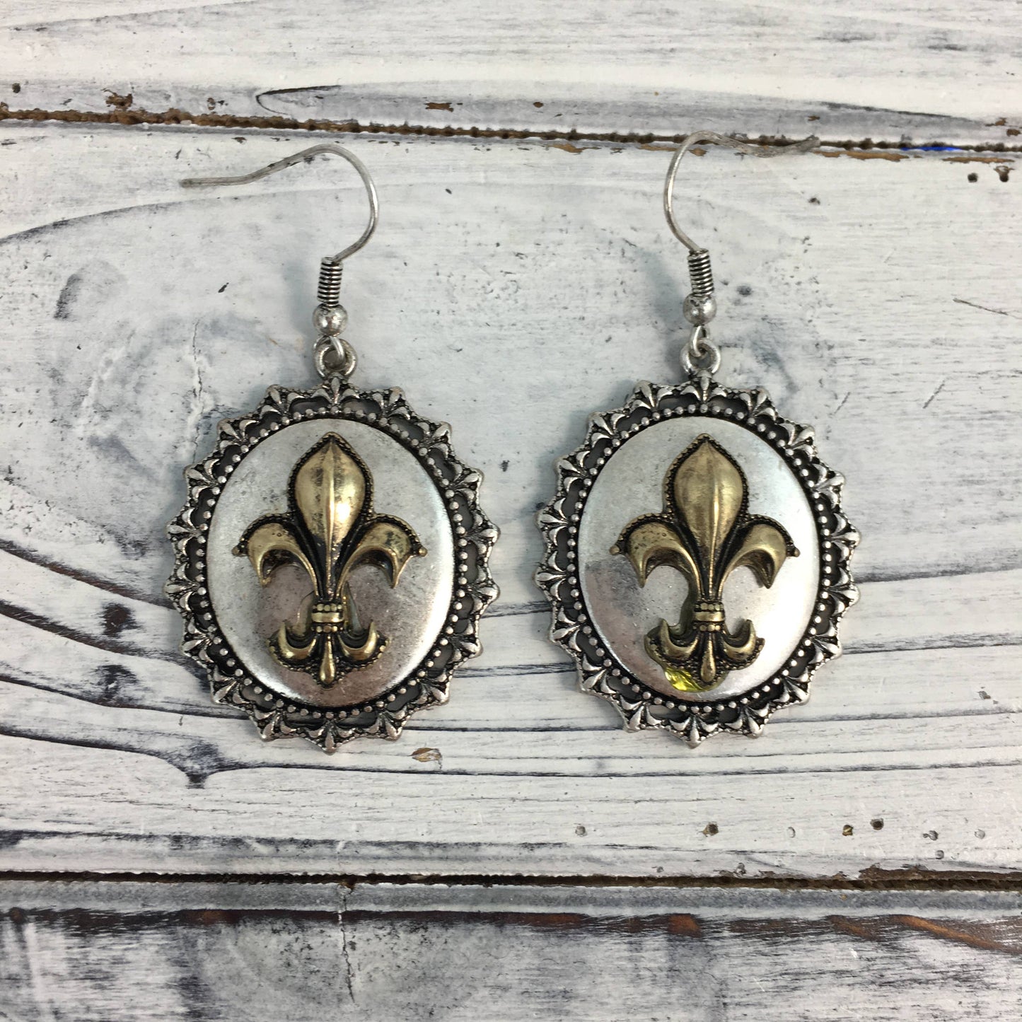 Ornate fleur de lis oval earrings 