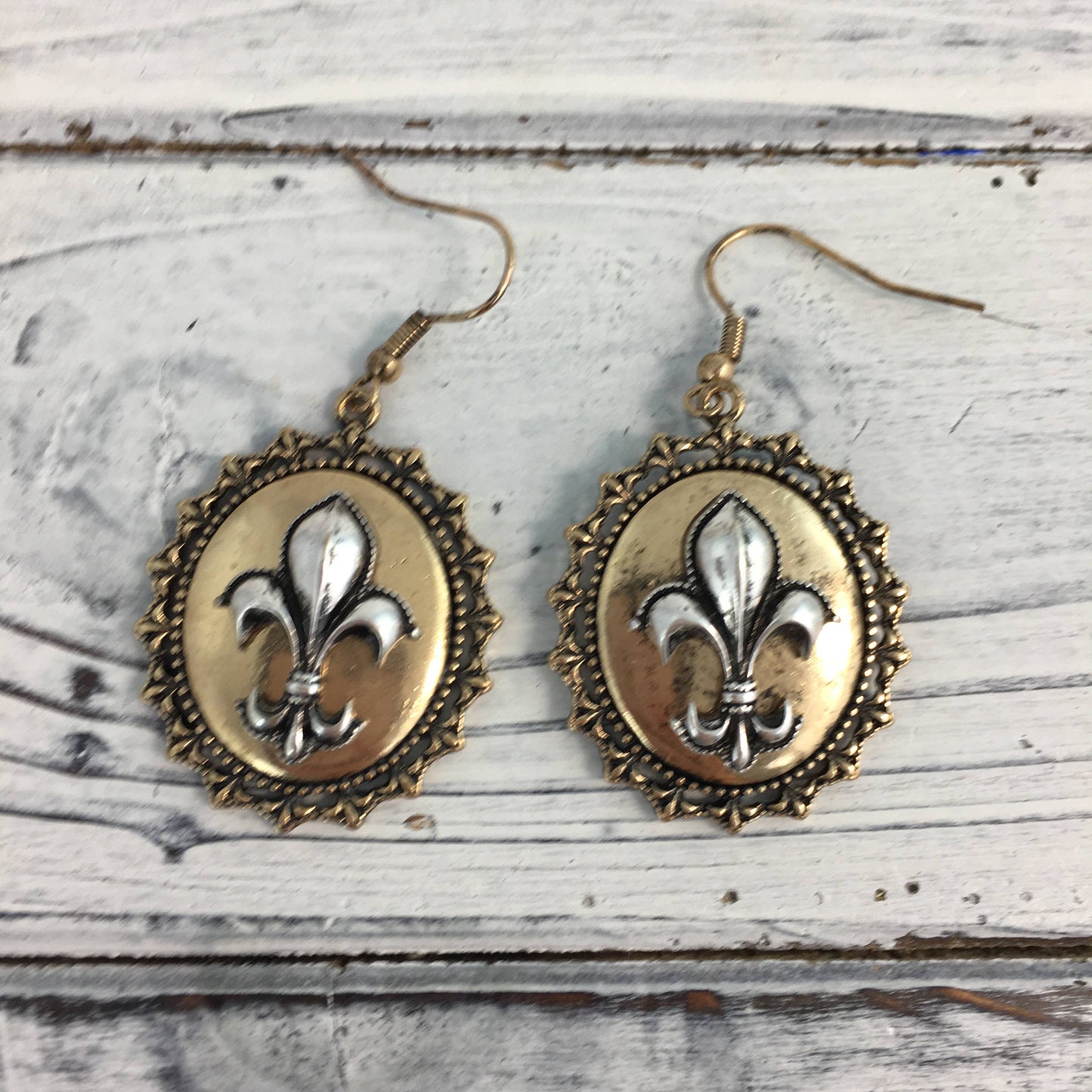 Ornate fleur de lis oval earrings 