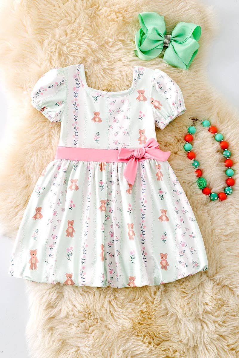 Teddy bear printed on bubble sleeve dress with pink side bow.